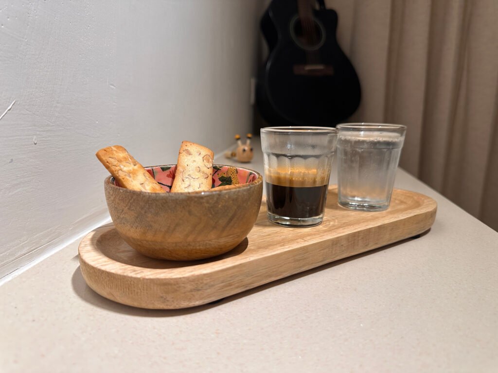 Espresso Sidecar 4 The espresso sidecar set-up on a wooden tray: almond biscuits in a floral bowl, a glass of espresso and a glass of sparkling water